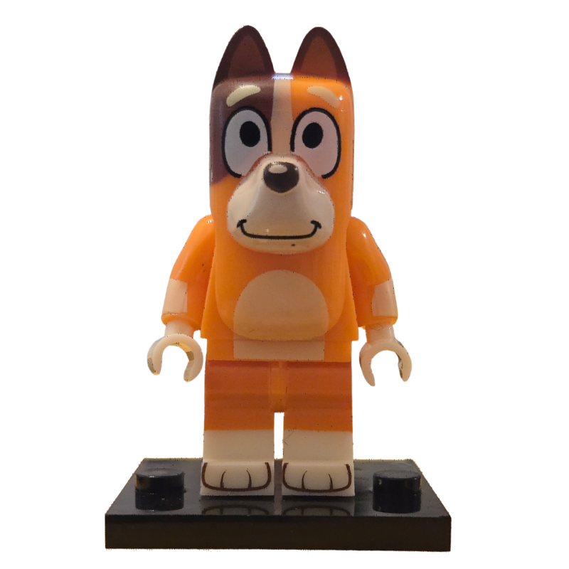 Toy figure of a dog with an orange outfit on a white background