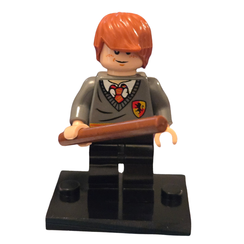 LEGO minifigure with red hair holding a broomstick on a white background