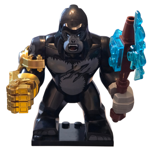 Toy gorilla figure with gold fist and blue weapon on a white background