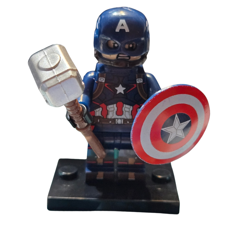 Toy figure of a superhero holding a hammer and shield on a white background