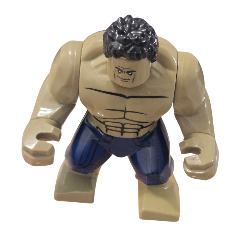 Toy figure of a muscular character with blue pants on a white background
