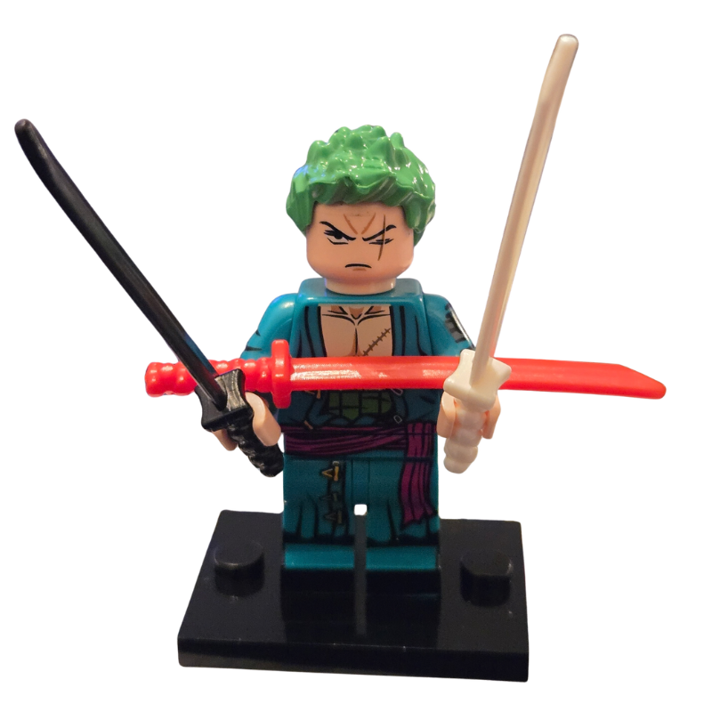 Toy figure with green hair holding a sword and a staff on a white background