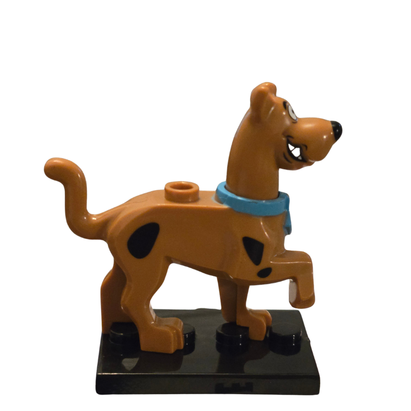 Toy figure of a dog with a blue collar on a white background