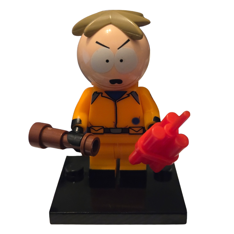 Toy figure in orange jumpsuit with weapon and red object on a white background