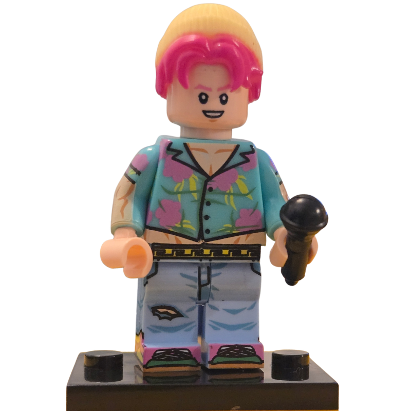 Toy figure with pink hair and colorful outfit holding a microphone on a white background
