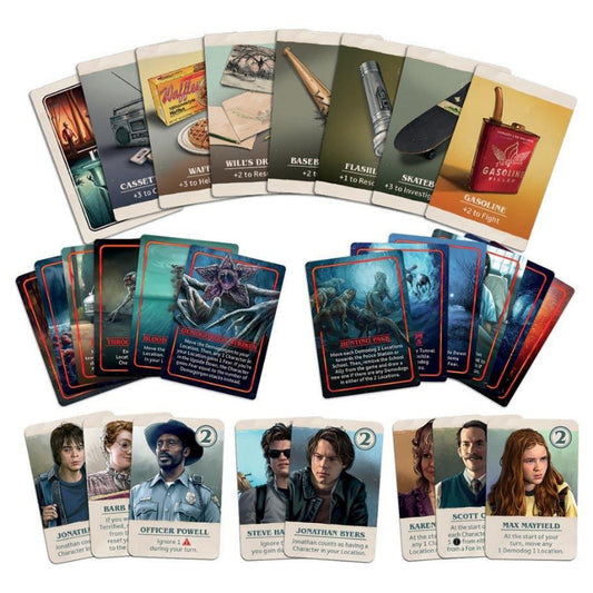 A set of board game cards arranged on a white background, showing multiple face-up and face-down player cards with illustrated scenes and character portraits.