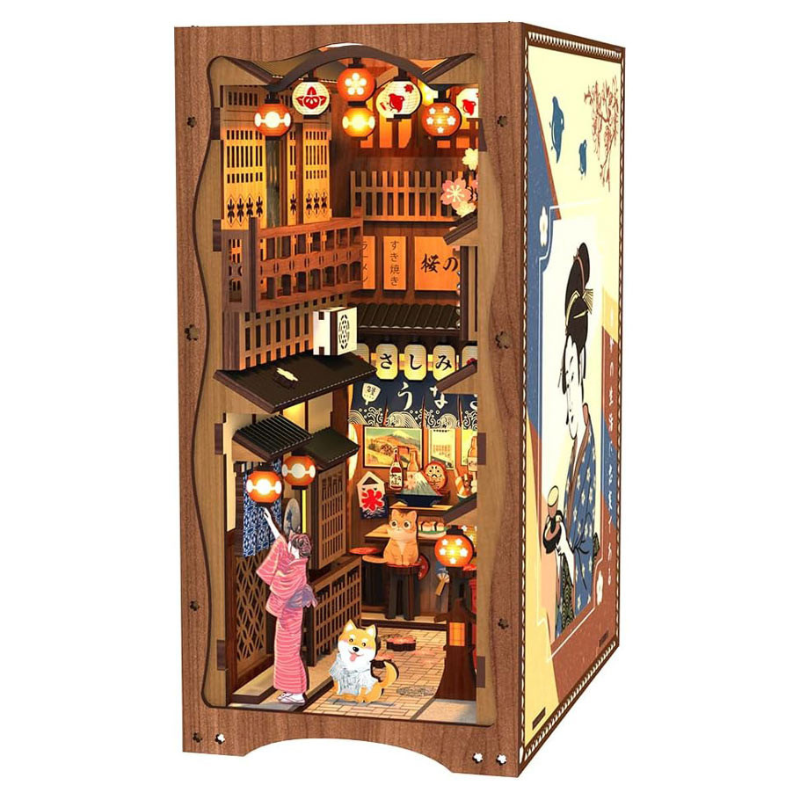 Wooden model of a traditional Japanese street scene with lanterns and people.