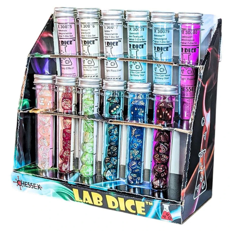 A retail display box filled with multiple small clear tubes labeled 'CHESSX LAB DICE,' each containing assorted polyhedral gaming dice in different colors and patterns.