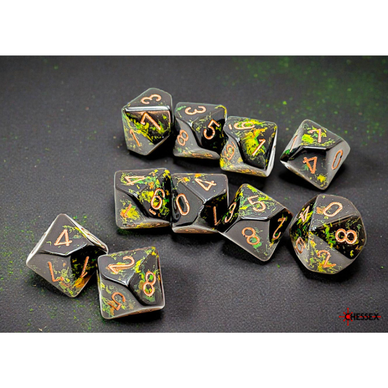 A set of black polyhedral gaming dice with metallic gold numbers and green glitter flecks, arranged on a dark textured surface.