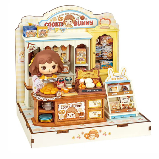 A Calico Bunny toy playset featuring a detailed cookie shop counter and display stand with a Cookie Bunny figure, toy food items, shelves, and a yellow display cabinet, all on a white background.