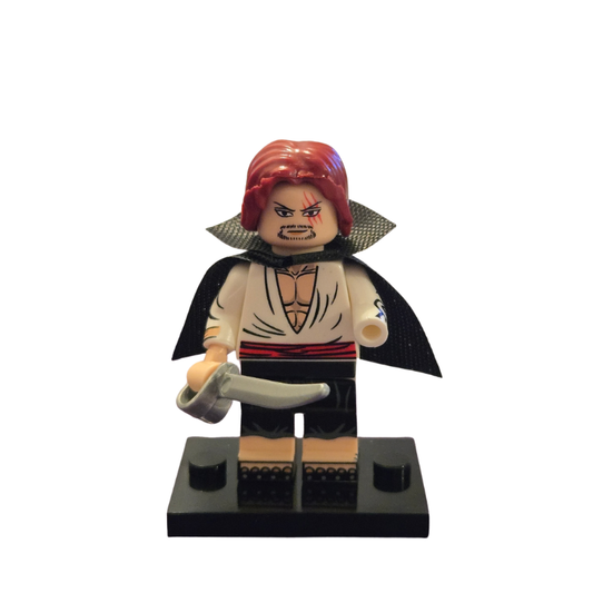 Toy figure with red hair and a cape holding a sword on a white background
