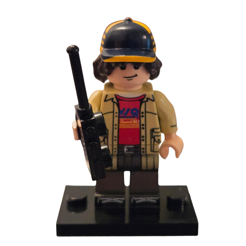 Toy figure with a cap, jacket, and walkie-talkie on a white background