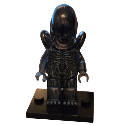 Black alien-like figure on a white background