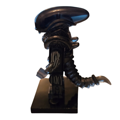 Alien figurine with a dark background