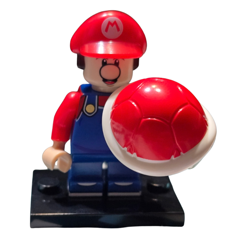 Toy figure of a character with a red hat and blue overalls holding a large red mushroom on a white background