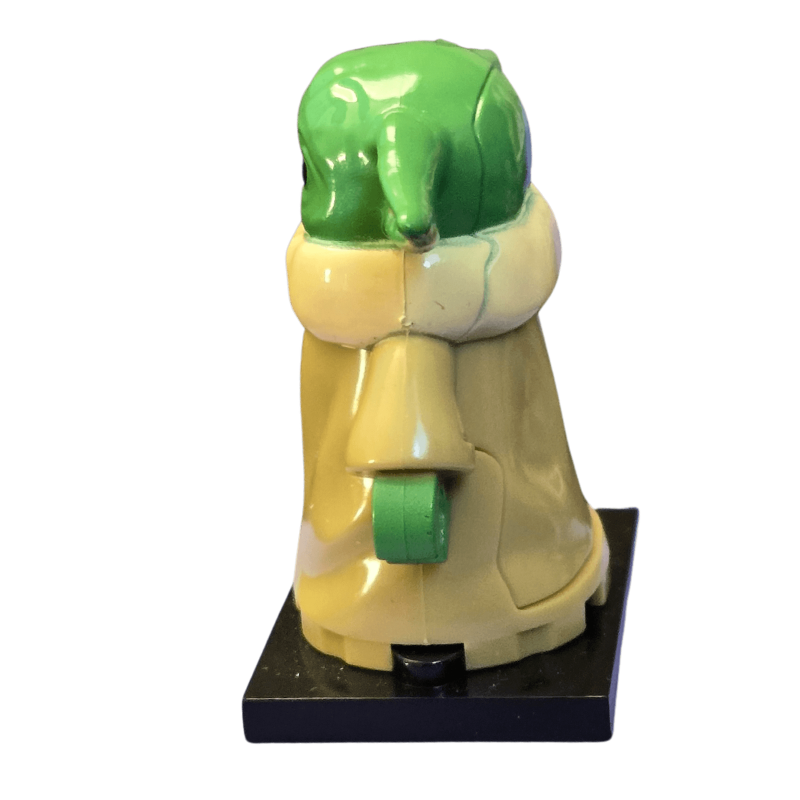 Toy figure of a character with green head and yellow body on a white background