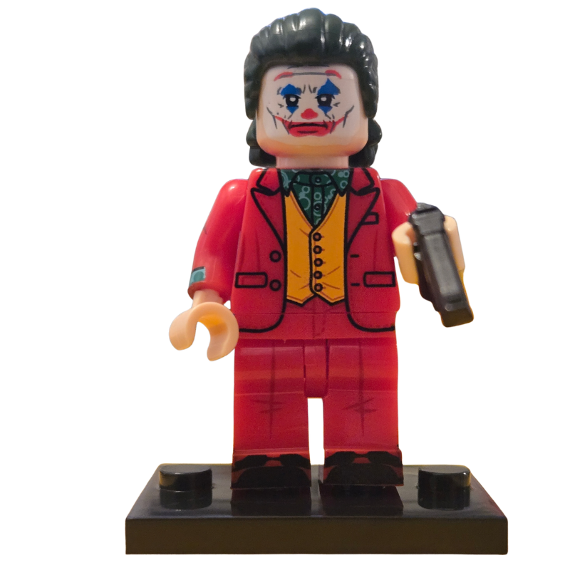 Toy figure of a character in a red suit with a gun on a white background