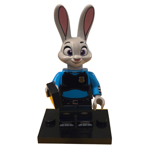 Toy figure of a rabbit character in a blue shirt and black pants on a white background