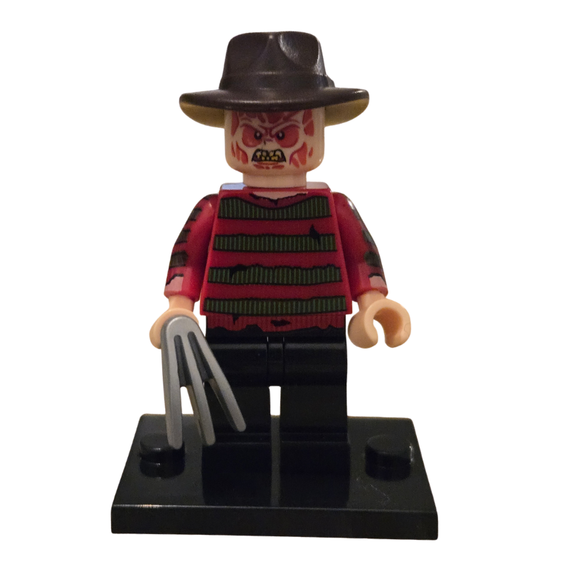 Toy figure resembling a character with a hat and red and black striped shirt holding a knife on a white background