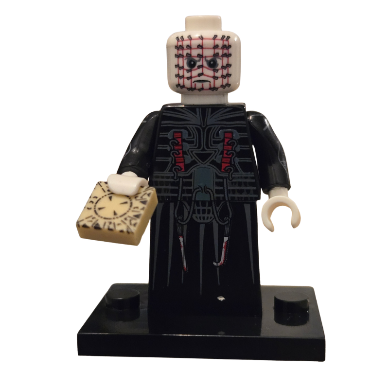 Toy figure with a black outfit and clock, on a white background