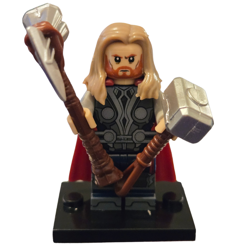 Thor action figure with hammer and cape on a white background