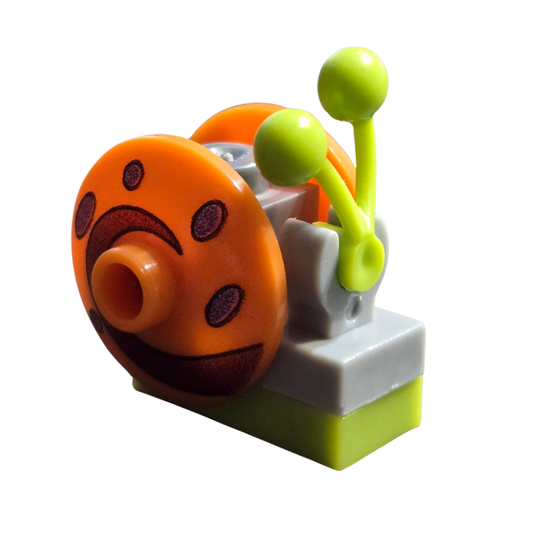 Toy snail figure with an orange shell and green body on a white background