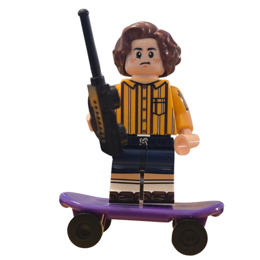 Toy figure of a person with a bat and purple skateboard on a white background