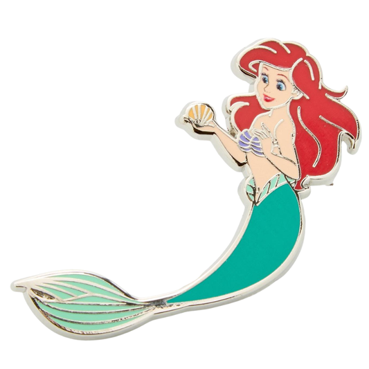 An enamel pin of the character Ariel from The Little Mermaid, featuring her signature red hair, purple shell top, and teal-green tail, set against a plain white background.
