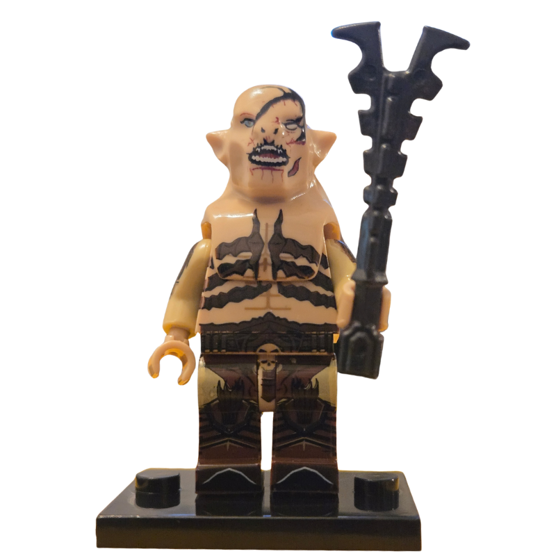 Toy figure with tribal design holding a weapon on a white background