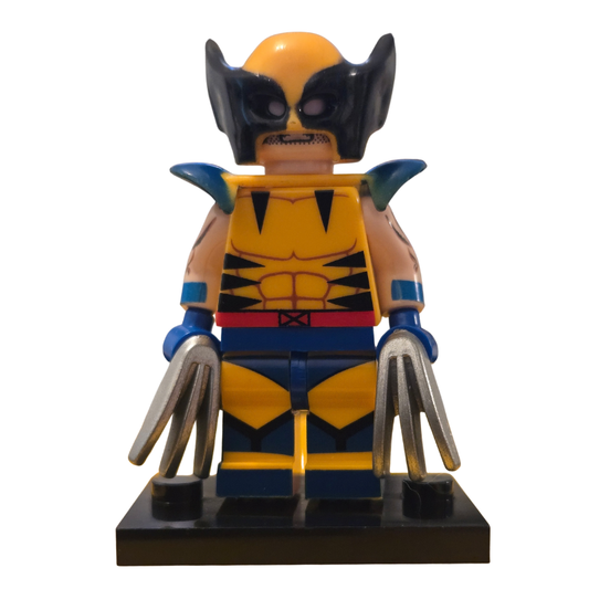 Toy figure of a superhero in a yellow and blue costume with claws on a white background