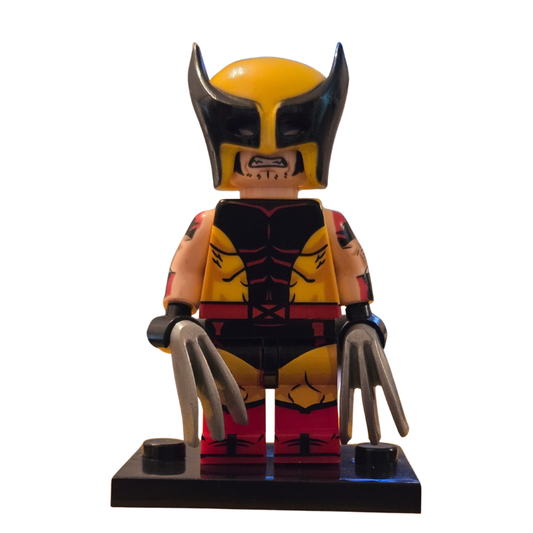 Toy figure of a superhero with yellow helmet and red and black suit on a white background
