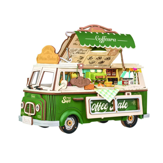 A 3D wooden model of a vintage coffee van, featuring green and cream panels, an open roof displaying miniature coffee accessories, and detailed interior shelves, isolated on a white background.