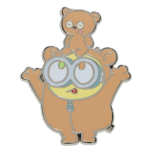 A cartoon enamel pin featuring a brown bear-like character with large round goggles and a smaller matching bear sitting on its head, shown on a plain white background.