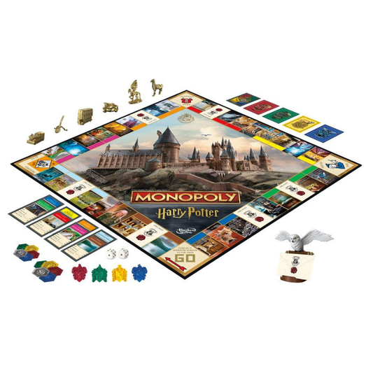 Monopoly Harry Potter board game set displayed on a white background, showing the board, play cards, money, player tokens, and character pieces including a golden hogwarts key and a silver owl token.