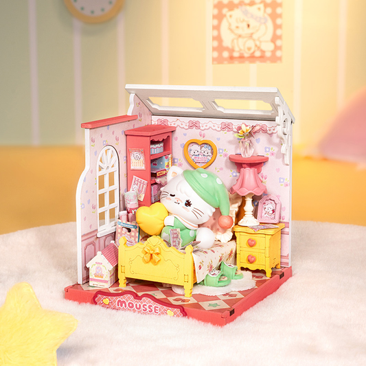 Miniature dollhouse with colorful furniture and a character on a white surface.