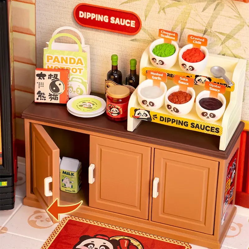Play kitchen set with panda-themed dipping sauces and a cabinet.
