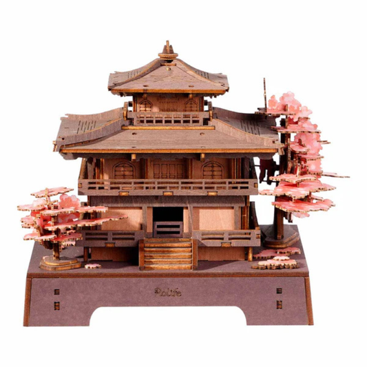 A 3D wooden model of a traditional Japanese pagoda-style temple with pink cherry blossom trees, displayed on a brown base against a white background.