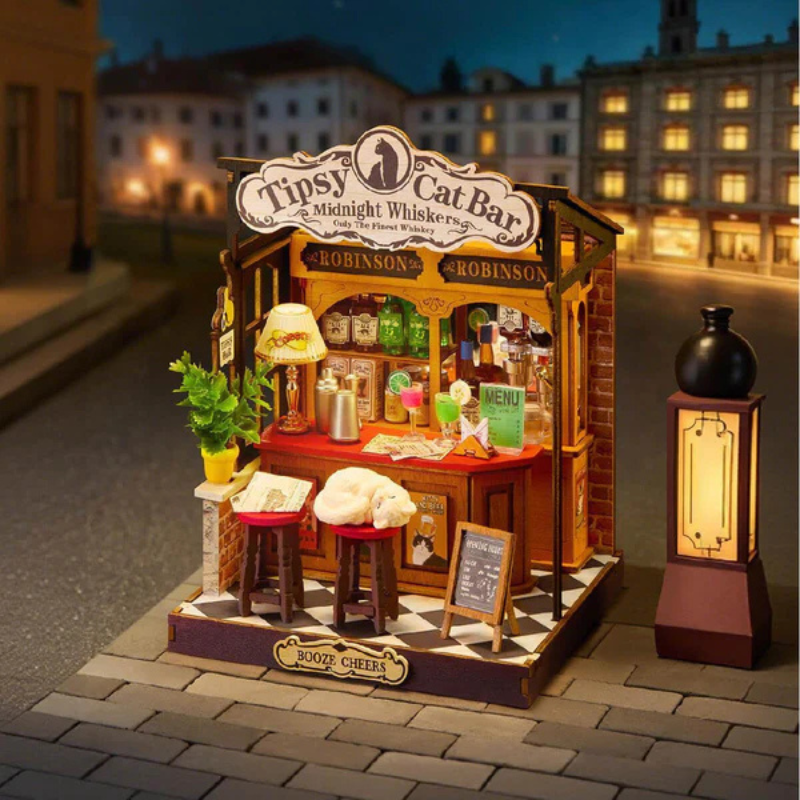 Model of a cat bar with 'Tipsy Cat Bar' sign on a street at night.